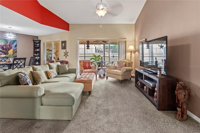 living area with lofted ceiling, carpet, baseboards, and a ceiling fan