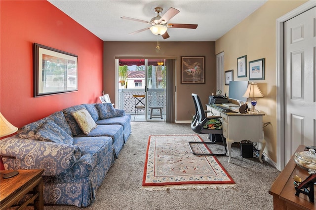 carpeted home office featuring ceiling fan, a textured ceiling, and baseboards