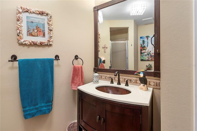 full bath with a shower stall and vanity