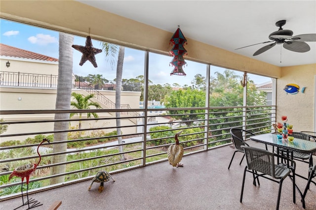 sunroom / solarium with a wealth of natural light and ceiling fan