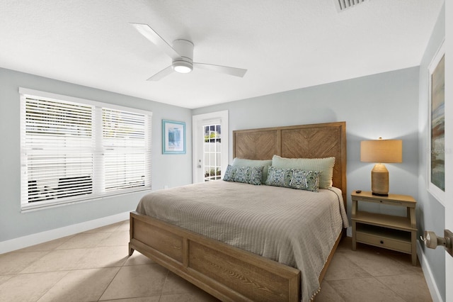 bedroom with light tile patterned floors, a ceiling fan, and baseboards