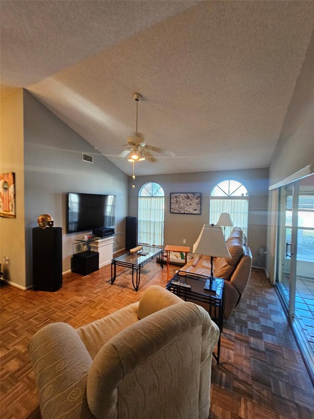 living room with baseboards, visible vents, lofted ceiling, ceiling fan, and a textured ceiling