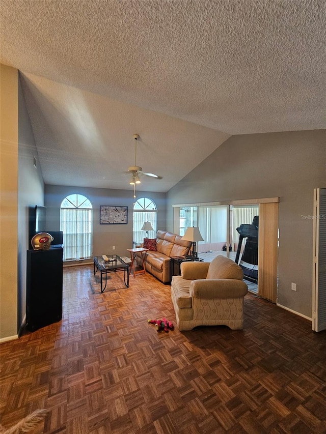 living area with ceiling fan, baseboards, vaulted ceiling, and a textured ceiling