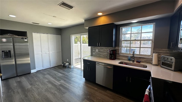 kitchen featuring light countertops, appliances with stainless steel finishes, a sink, and visible vents