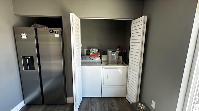 clothes washing area with laundry area, dark wood-type flooring, and washing machine and clothes dryer