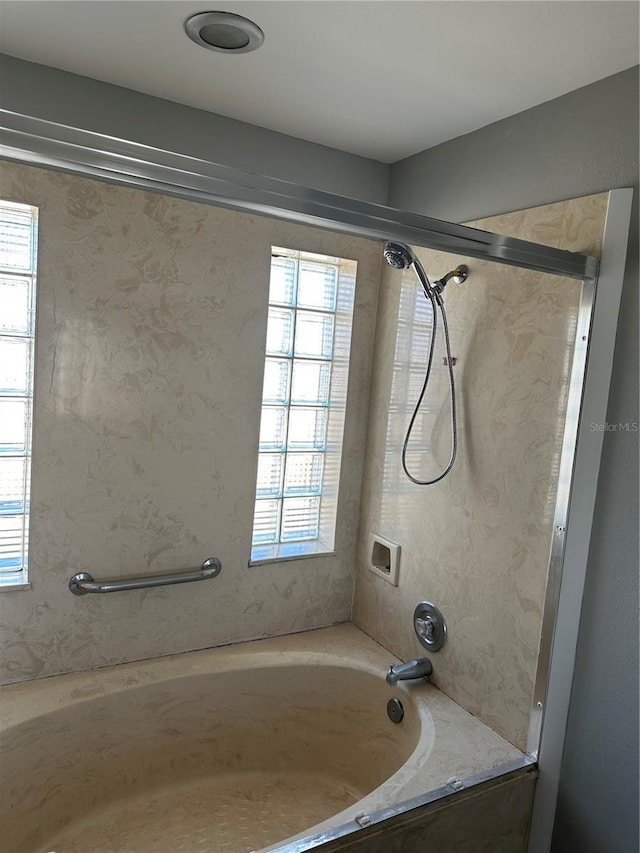 full bathroom featuring a healthy amount of sunlight and shower / bathtub combination