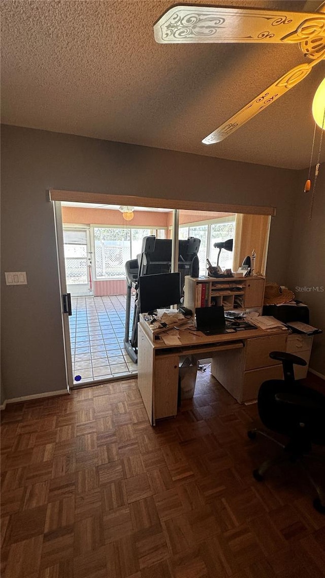 home office featuring a healthy amount of sunlight and a textured ceiling