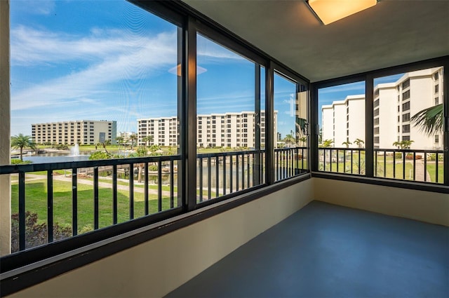 unfurnished sunroom featuring a view of city