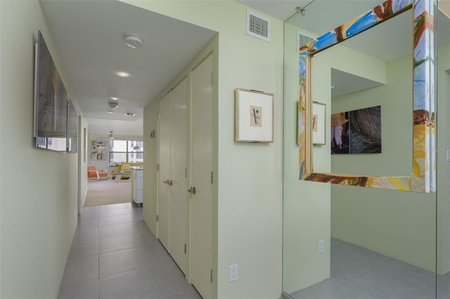 hallway with visible vents and tile patterned floors