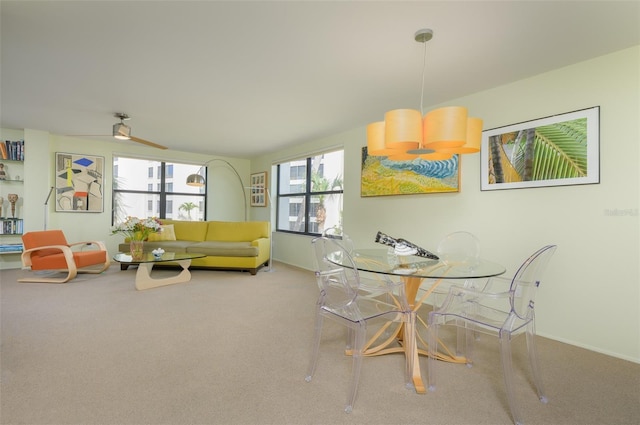 dining area with ceiling fan, carpet, and baseboards