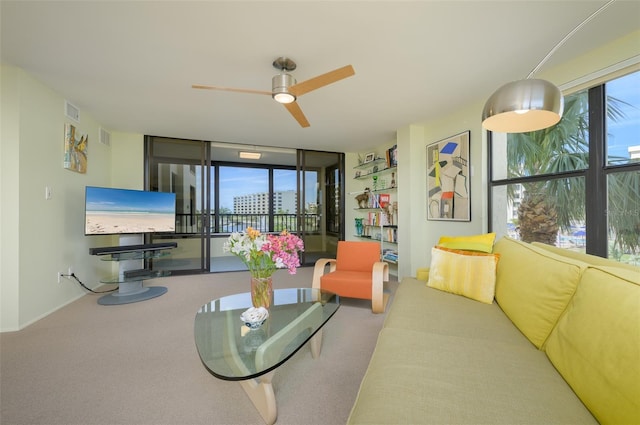 living area with a ceiling fan, carpet, visible vents, and baseboards