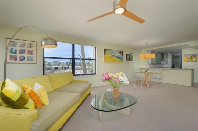 living room featuring carpet and a ceiling fan