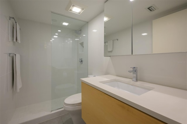 full bath with toilet, visible vents, walk in shower, and vanity