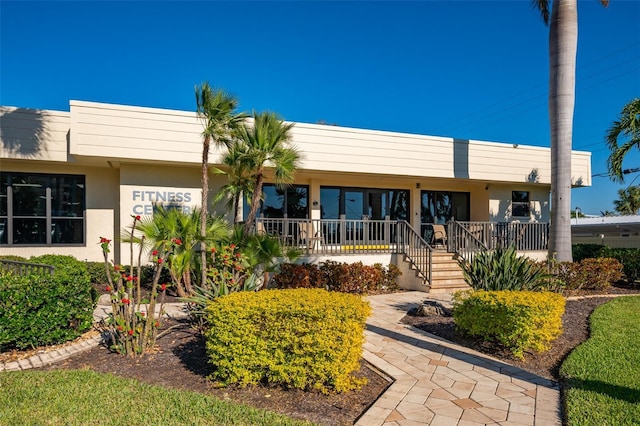 view of front of house featuring covered porch and stucco siding