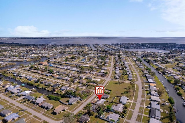 bird's eye view featuring a water view and a residential view