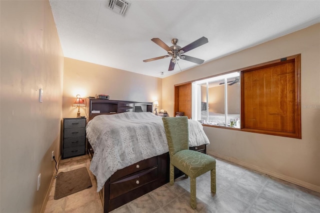 bedroom featuring a ceiling fan, visible vents, and baseboards