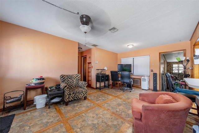 office area with visible vents, a textured ceiling, and baseboards