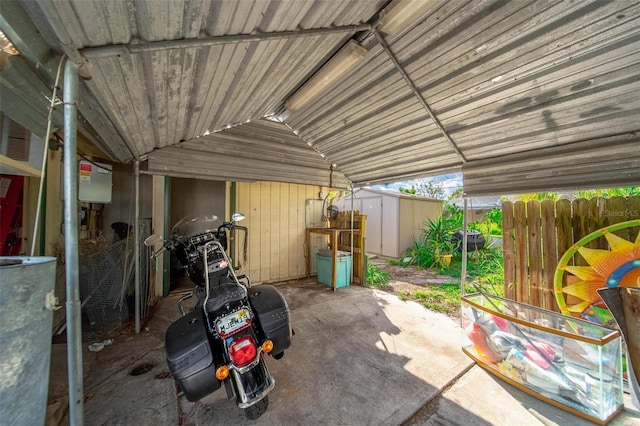 view of patio / terrace with an outbuilding, a shed, and fence