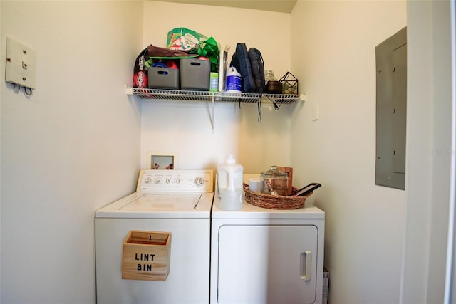 laundry room with electric panel and separate washer and dryer