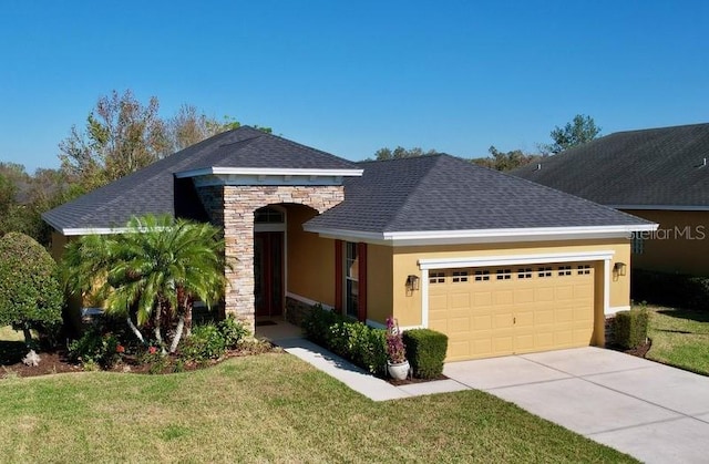 view of front of property with a garage and a front lawn