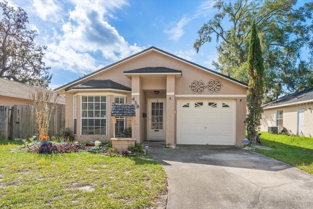 view of front of home featuring central AC, a front yard, and a garage