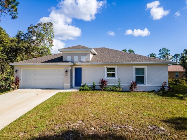 view of front facade with a front yard and a garage