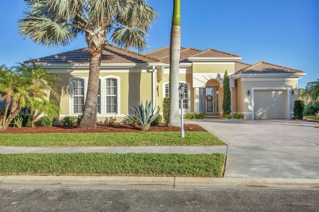 view of front of house featuring a front yard and a garage