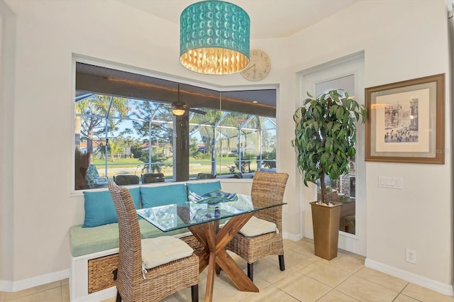 dining area featuring tile patterned flooring and ceiling fan with notable chandelier