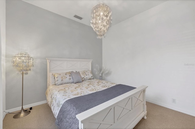 bedroom featuring carpet and an inviting chandelier