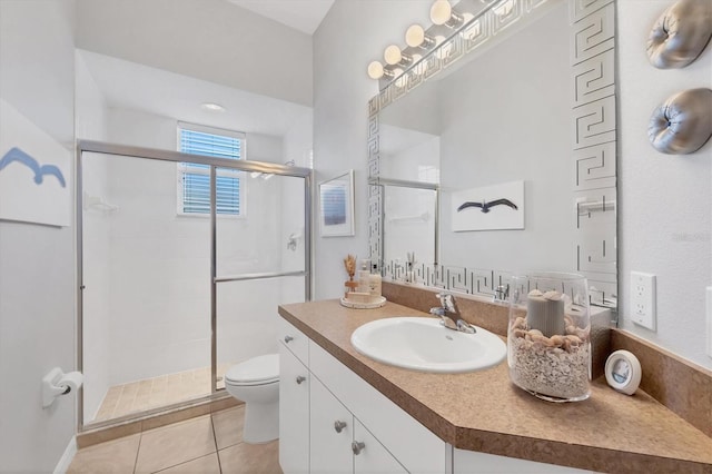 bathroom with tile patterned flooring, toilet, vanity, and walk in shower