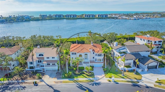 birds eye view of property featuring a water view and a residential view