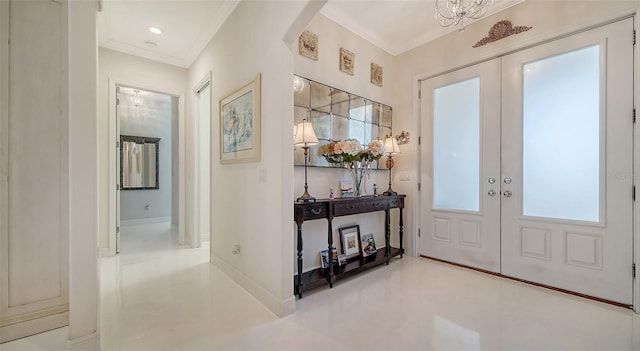 foyer entrance featuring arched walkways, french doors, crown molding, and baseboards