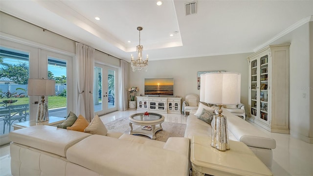 living room featuring recessed lighting, visible vents, ornamental molding, french doors, and a raised ceiling