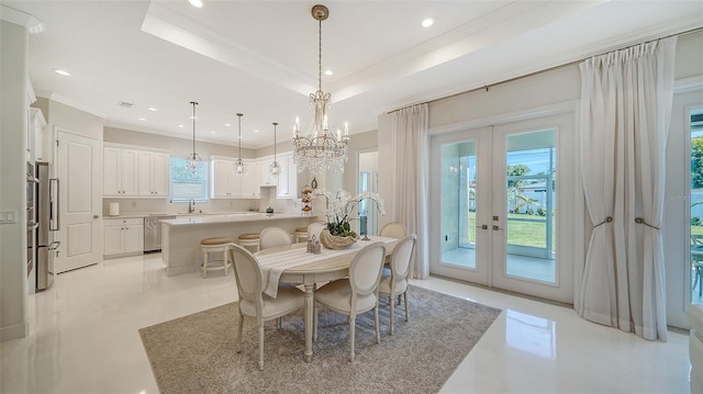 dining space with ornamental molding, french doors, a raised ceiling, and recessed lighting