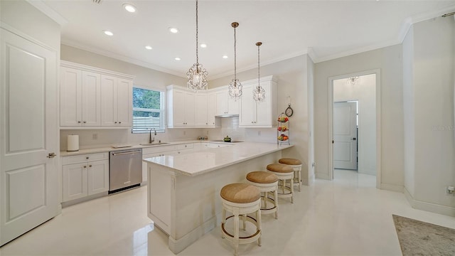 kitchen featuring a breakfast bar, white cabinets, a peninsula, and stainless steel dishwasher