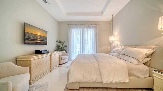 bedroom with a raised ceiling and visible vents