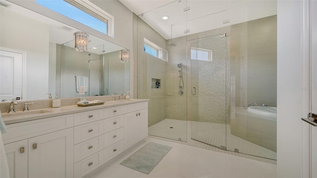 bathroom with a stall shower, plenty of natural light, and a sink