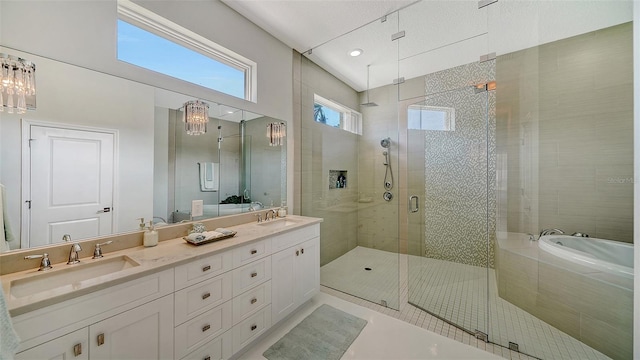 full bathroom featuring a stall shower, a sink, a bathing tub, and double vanity