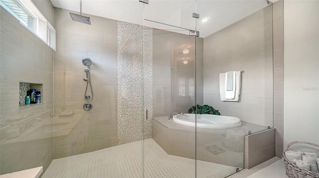 full bathroom with a stall shower and a bath