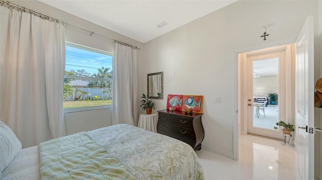 bedroom with lofted ceiling, visible vents, and baseboards