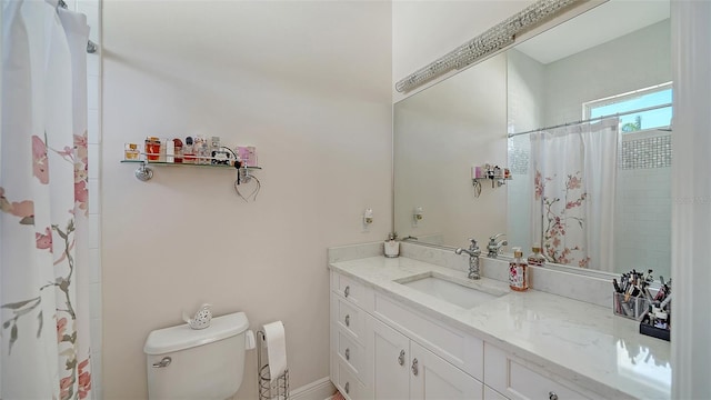 full bathroom featuring toilet, vanity, and a shower with curtain