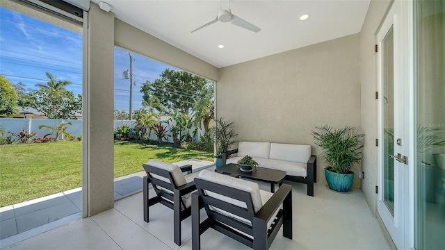 sunroom featuring ceiling fan