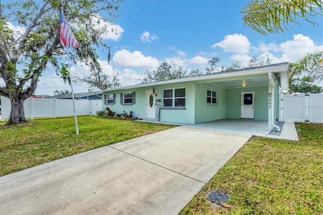 single story home with driveway, stucco siding, a gate, fence, and a front yard