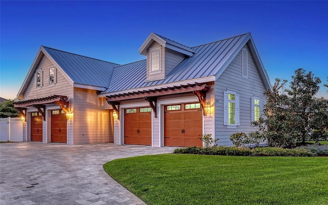 1543 Eastbrook Dr, Sarasota, FL 34231 - view of front of home featuring a standing seam roof, metal roof, decorative driveway, a front yard, and a garage