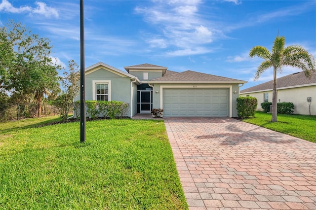 view of front of house with a front yard and a garage