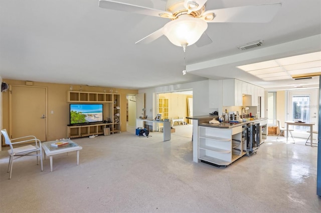 kitchen featuring sink, white cabinets, and ceiling fan