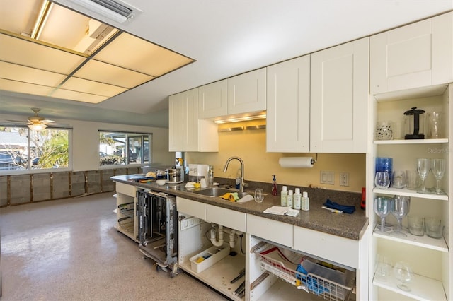 kitchen with ceiling fan, white cabinets, sink, and beverage cooler