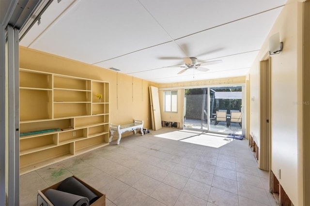 unfurnished living room with light tile patterned flooring and ceiling fan