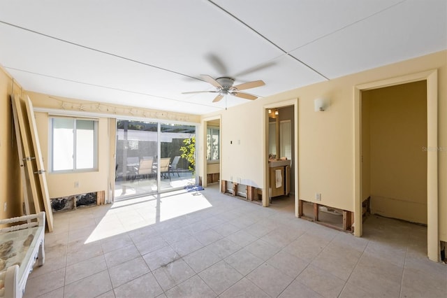 unfurnished room with ceiling fan and light tile patterned floors