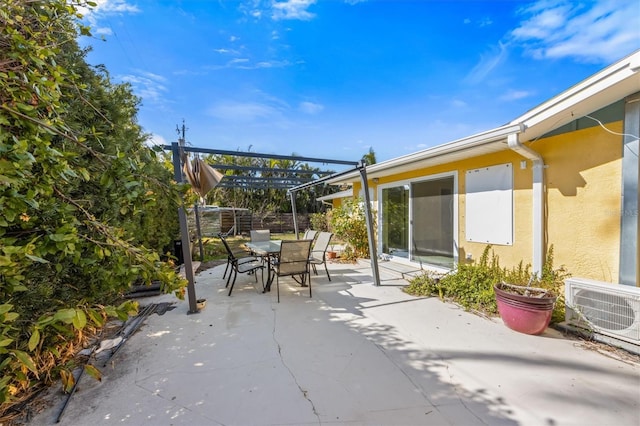 view of patio featuring ac unit and a pergola